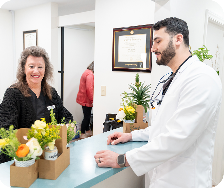 Patient speaking with dentist at front desk
