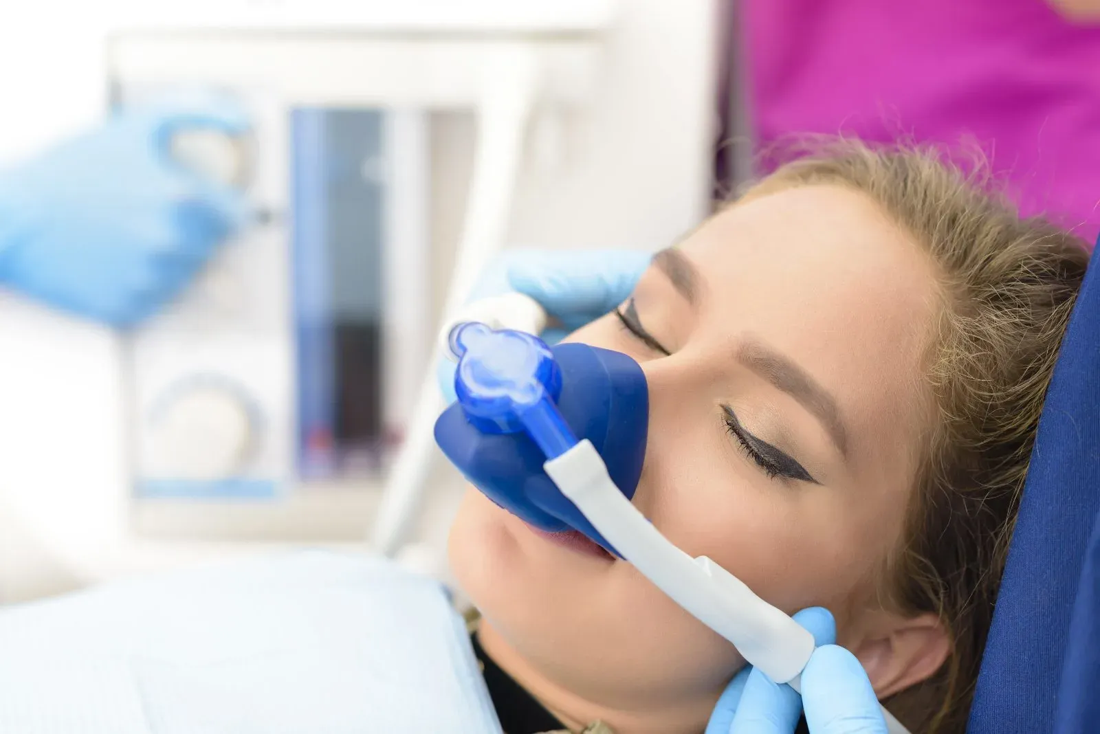 Patient relaxing with a sedation mask before treatment