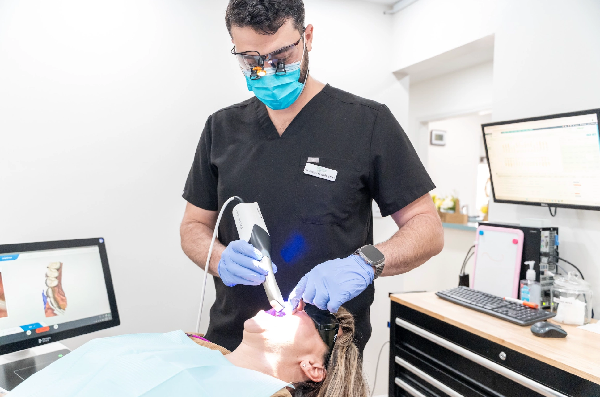 Dentist using a 3D intraoral scanner during a same-day crown appointment
